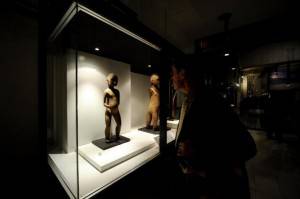 A visitor looks at an Aboriginal wooden