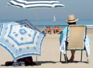 People enjoy a sunbath on the beach in H