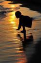 A young girl plays during sunset at the Getty Images