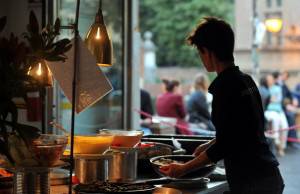 A waiter displays dishes during the aper