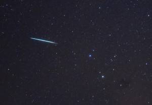 A meteor (L) from the Geminids meteor sh
