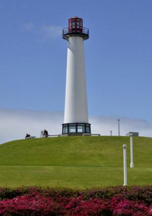A visitor rests under the lighthouse in