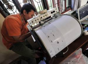 A geologist prepares his instruments to