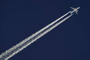 A commercial plane flies over the ski re