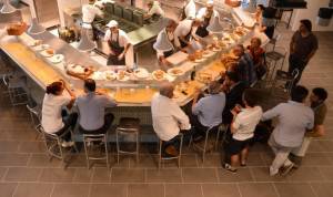 This picture shows people eating at a co
