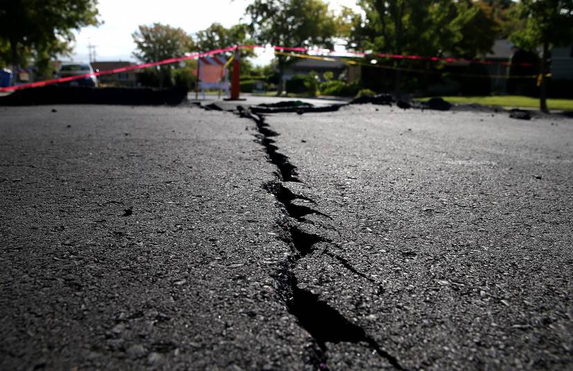NAPA, CA - AUGUST 26:  A crack runs down the center of an earthquake-damaged street on August 26, 2014 in Napa, California.  Two days after a 6.0 earthquake rocked the Napa Valley, residents and wineries are continuing clean up operations.  (Photo by Justin Sullivan/Getty Images)