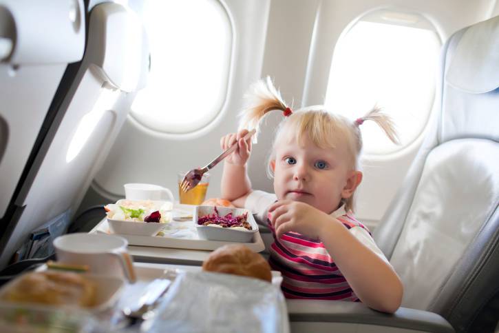 girl eating in the airplane