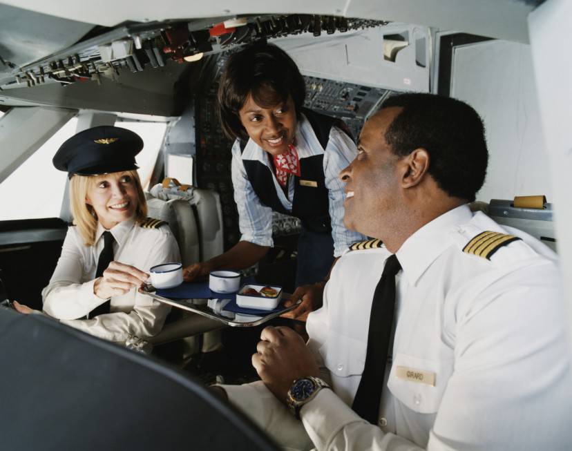 Air Hostess Serves Coffee to the Pilots in the Cockpit