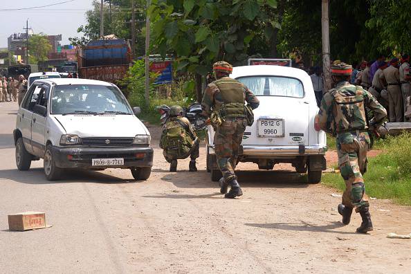 Indian Army personnel take position during an encounter with armed attackers at the police station in Dinanagar town, in the Gurdaspur district of Punjab state on July 27, 2015. Indian security forces were battling an armed attack on a police station near the Pakistan border in which at least five people have been killed. AFP PHOTO/ NARINDER NANU (Photo credit should read NARINDER NANU/AFP/Getty Images)