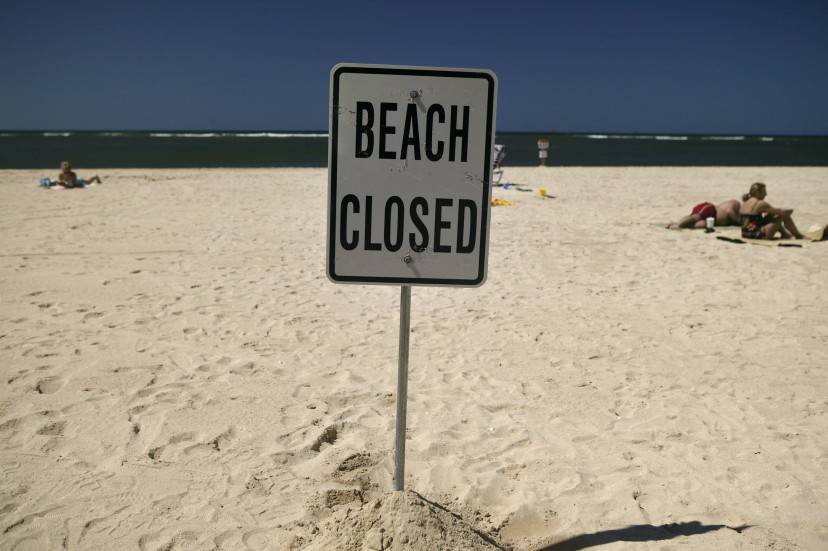 HONOLULU, HI - APRIL 3:   A closed beach sign is posted on Ft. DeRussy Beach in Waikiki Beach April 3, 2006 in Honolulu, Hawaii. With near perfect weather across Oahu, Waikiki Beach is near empty of swimmers due to the sewage spill which diverted millions of gallons of raw sewage into a nearby canal last week. High levels of bacteria were detected in the water forcing the Hawaiian Department of Health to close several of Waikiki's most famous beaches.  Warning signs were posted along most of Waikiki in English and Japanese.  (Photo by Marco Garcia/Getty Images)