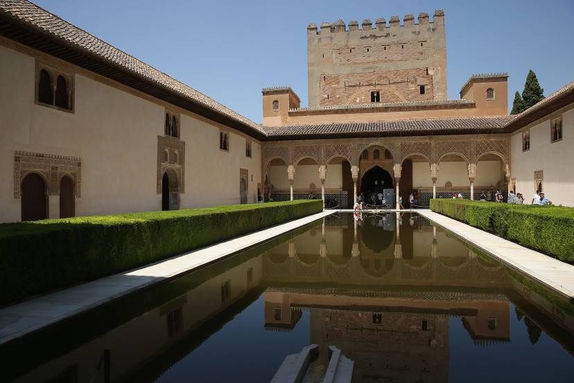 GRANADA, SPAIN - JULY 20: Visitors gaze at the reflecting pool in the Court of the Myrtles in the Nasrid Palaces at the Alhambra on July 23, 2013 in Granada, Spain. Southern Spain is among Europe's biggest tourist destinations. (Photo by Sean Gallup/Getty Images)