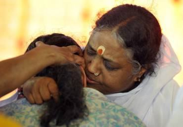 Indian spiritual figure Mata Amritanandamayi (R), known by her followers as amma (mother), hugs a devotee during an event in Hyderabad on March 15, 2015. Mata Amritanandamayi, popularly known as the 'hugging saint', is on a two-day visit in the southern Indian state of Telangana as part of her 'Bharat Yatra' tour. AFP PHOTO/ Noah SEELAM        (Photo credit should read NOAH SEELAM/AFP/Getty Images)