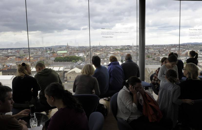 Visitors look at the city of Dublin from the top of the Guinness Storehouse, in Dublin on July 20, 2009. AFP PHOTO / MIGUEL RIOPA        (Photo credit should read MIGUEL RIOPA/AFP/Getty Images)