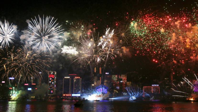 Fireworks explode over Victoria Harbour in Hong Kong on January 1, 2015. Just like previous years, the city's iconic skyline along Victoria Harbour will light up with an eight-minute pyrotechnic display, as tens of thousdands of partygoers will flock to the waterfront to celebrate.    AFP PHOTO / ISAAC LAWRENCE        (Photo credit should read Isaac Lawrence/AFP/Getty Images)