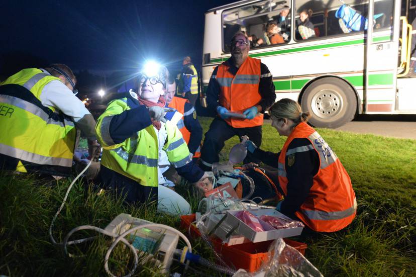 Firefighters and emergency physicians treat a casualty during an exercise simulating a school bus accident with a truck, in Cherre, north-western France, on October 19, 2015. The crash test provides an opportunity for the firefighters to display and test the plan the 'numerous victim security plan' (nombreuses victimes, NOVI). AFP PHOTO / JEAN-FRANCOIS MONIER        (Photo credit should read JEAN-FRANCOIS MONIER/AFP/Getty Images)