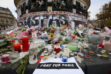 PARIS, FRANCE - NOVEMBER 16:  Flowers and tributes are left at the base of the Statue de Marianne at the Place de la Republique as a mark of respect to the victims of the Paris terror attacks last Friday, on November 16, 2015 in Paris, France. There will be a Europe-wide one-minute silence at 12pm CET today in honour of the 129 people who were killed last Friday in a series of terror attacks in the French capital. (Photo by Christopher Furlong/Getty Images)