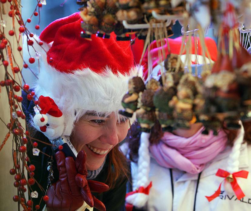 A tourist looks at Christmas decorations 24 November 2007 during the opening to the public of the Strasbourg Christmas market, which is the largest and one of the oldest French Christmas markets and attracts thousands of visitors every year.  The market dates back to 1570 and is known in the local Alsatian dialect as Christkindelsmarik.  AFP PHOTO / FREDERICK FLORIN (Photo credit should read FREDERICK FLORIN/AFP/Getty Images)