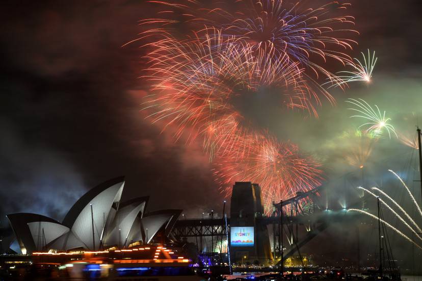 New Year's Eve fireworks erupt over Sydney's iconic Harbour Bridge and Opera House during the traditional fireworks show held at midnight on January 1, 2015. AFP PHOTO / Peter PARKS (Photo credit should read PETER PARKS/AFP/Getty Images)