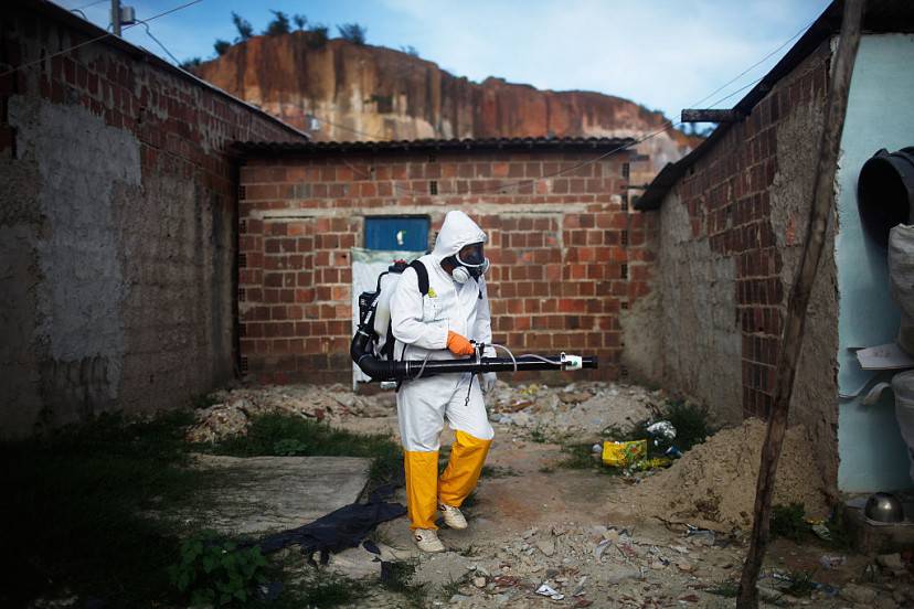 RECIFE, BRAZIL - FEBRUARY 04: A city worker fumigates in an effort to eradicate the mosquito which transmits the Zika virus on February 4, 2016 in Recife, Pernambuco state, Brazil. Officials say as many as 100,000 people may have already been exposed to the Zika virus in Recife, which is being called the epicenter of the crisis, although most never develop symptoms. Tourists are arriving in the city for its famed Carnival celebrations which begin tomorrow. (Photo by Mario Tama/Getty Images)