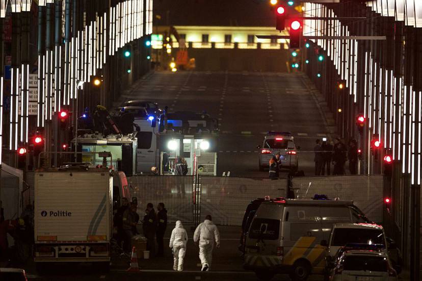 TOPSHOT - Forensic police units and investigators work in the Wetstraat - Rue de la Loi, which has been evacuated after an explosion at the Maelbeek - Maalbeek subway station in Brussels on March 22, 2016. Around 35 people were killed and more than 200 wounded in a series of attacks in Brussels today claimed by the Islamic State group and described as a strike at the very heart of Europe.  / AFP / BELGA / NICOLAS MAETERLINCK / Belgium OUT        (Photo credit should read NICOLAS MAETERLINCK/AFP/Getty Images)