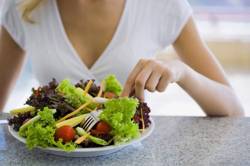 Woman eating salad