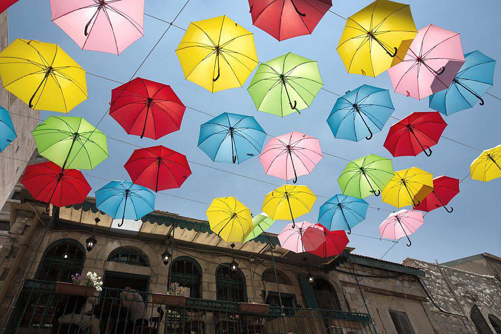 Coloured umbrellas decorate a main pedestrian street in Jerusalem on June 30, 2015, as the city's municipality opens more attractions and cultural activities in an effort to bring tourists and locals to visit the city. AFP PHOTO/MENAHEM KAHANA        (Photo credit should read MENAHEM KAHANA/AFP/Getty Images)