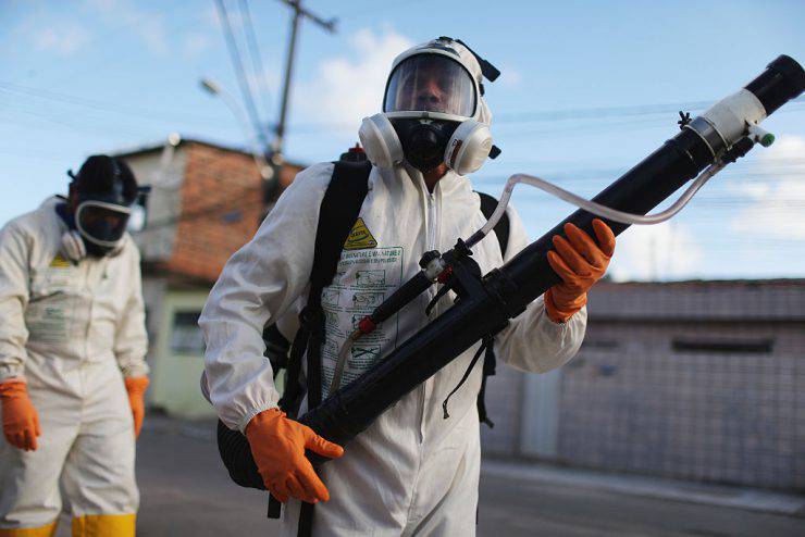 RECIFE, BRAZIL - JANUARY 28:  Health workers fumigate in an attempt to eradicate the mosquito which transmits the Zika virus on January 28, 2016 in Recife, Pernambuco state, Brazil. Two two-man teams were fumigating in the city today. Health officials believe as many as 100,000 people have been exposed to the Zika virus in Recife, although most never develop symptoms. In the last four months, authorities have recorded around 3,500 cases in Brazil in which the mosquito-borne Zika virus may have led to microcephaly in infants. The ailment results in an abnormally small head in newborns and is associated with various disorders including decreased brain development. According to the World Health Organization (WHO), the Zika virus outbreak is likely to spread throughout nearly all the Americas.  (Photo by Mario Tama/Getty Images)