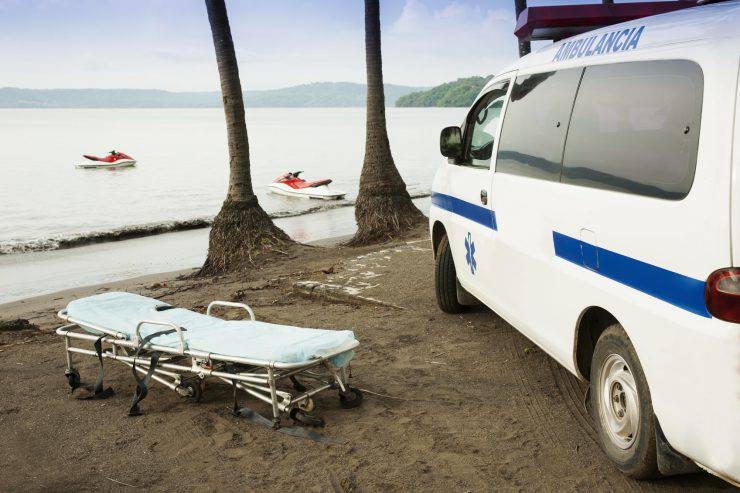 A photograph of an ambulance on a beach in Latin America.Please Browse: