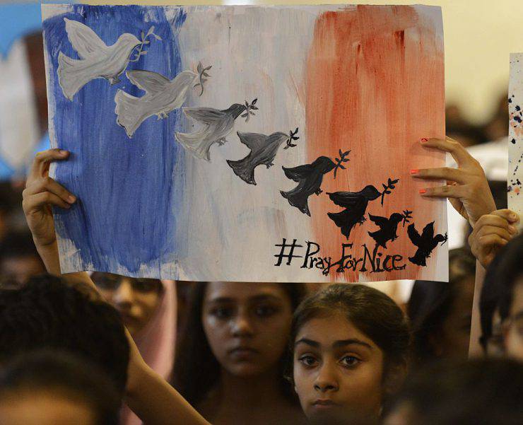 Indian students take part in a prayer meeting in memory of the victims of a truck attack in the French city of Nice at the Mahatma Gandhi International School (MGIS) in Ahmedabad on July 15, 2016.  French President Francois Hollande said July 15 that "many foreigners and young children" were among those killed or injured after the truck attack on a crowd celebrating Bastille Day in Nice, with around 50 fighting for their lives. At least 84 people were killed after a lorry ploughed into crowds celebrating Bastille Day in Nice. / AFP / SAM PANTHAKY        (Photo credit should read SAM PANTHAKY/AFP/Getty Images)