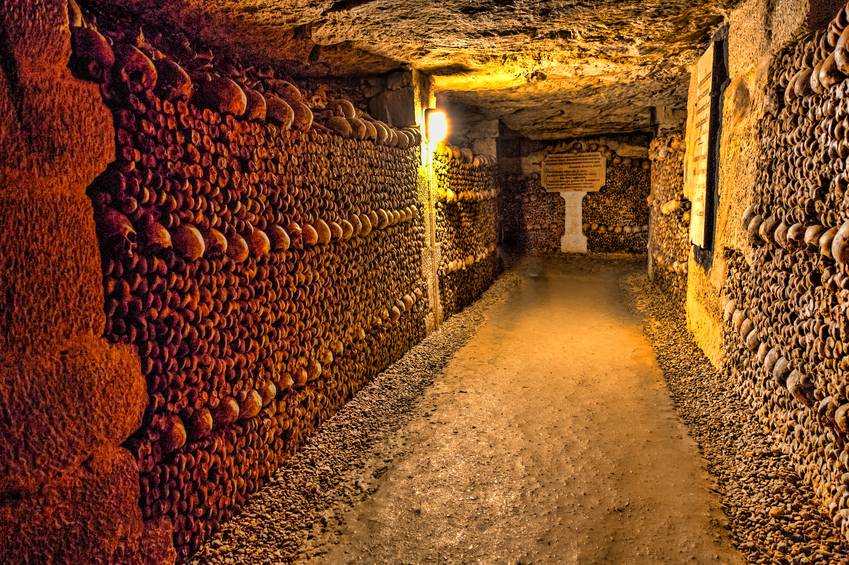 The Realm of the Dead, the Catacombs of Paris or Catacombes de Paris are underground ossuaries in Paris, France. Halls and caverns of walls of carefully arranged bones and skulls of over 6 million people.