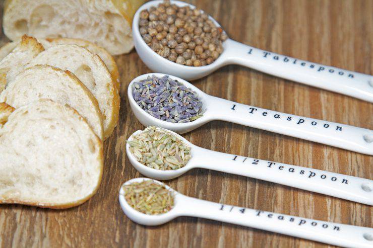 Old table-top selection of herbs and grains in measuring spoons