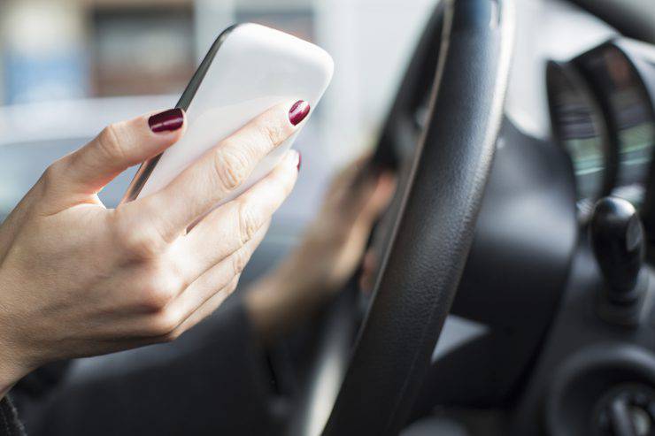 Reckless driving: woman texting in the car.