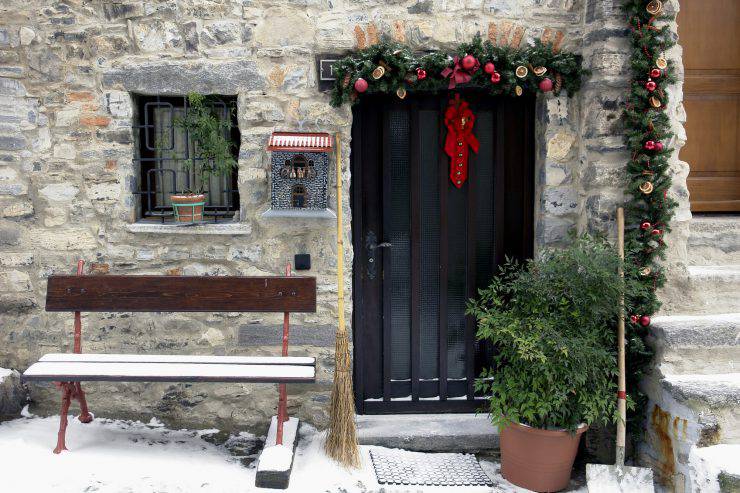 Entrance of a small italian cottage with christmas decoration.