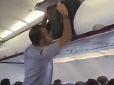 Passeggero lotta con bagaglio in aereo, l'hostess risolve tutto -Video
