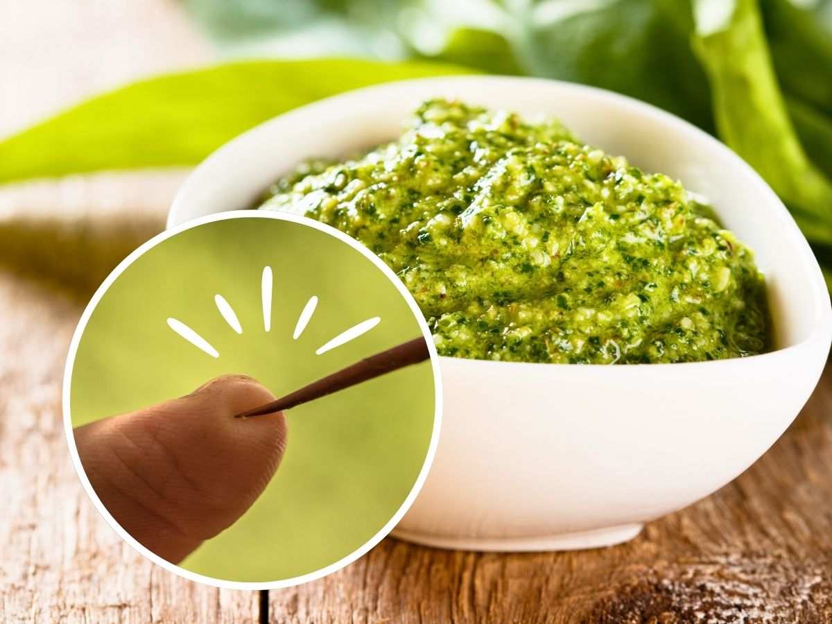 sfondo pesto e tondo con dito che si punge