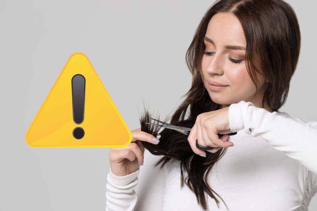 Donna che si taglia capelli e simbolo pericolo