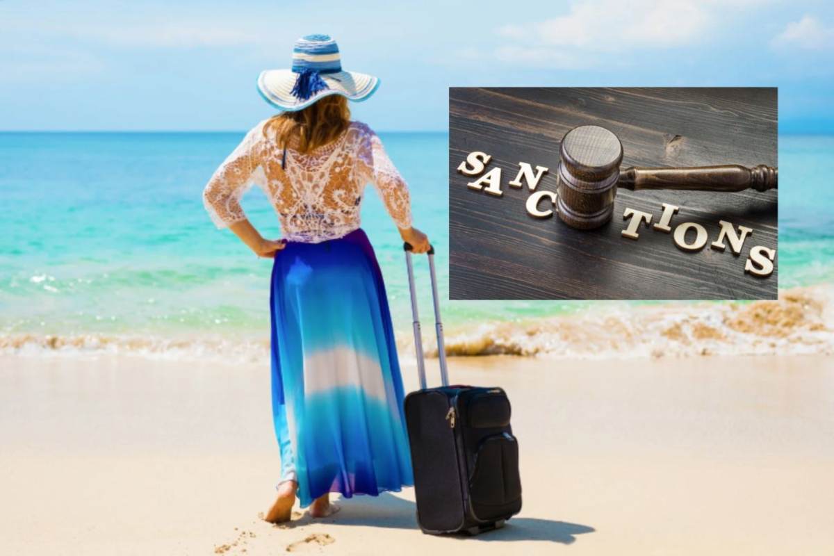 donna in spiaggia con un trolley