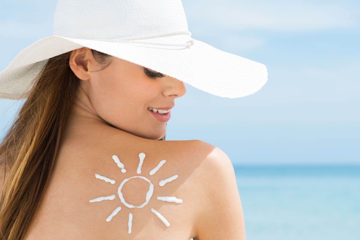 Donna con cappellino in spiaggia