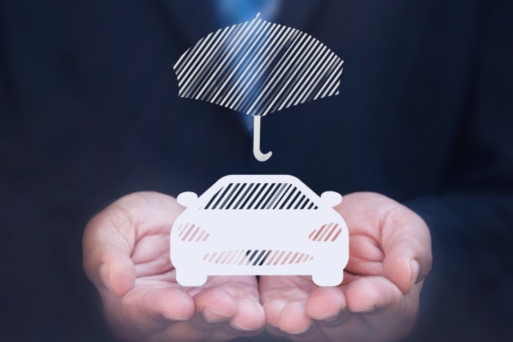 auto in miniatura appoggiata su due mani di uomo