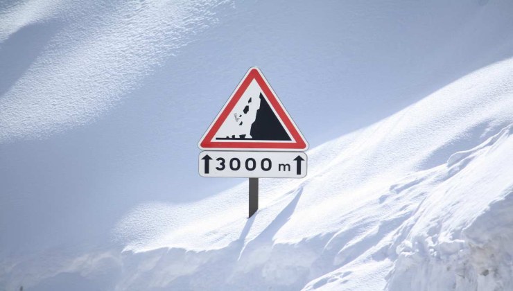 Segnale pericolo valanga immerso nella neve