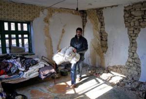 A Bulgarian man collects his belongings